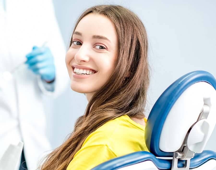 smiling woman sitting in a dental chair